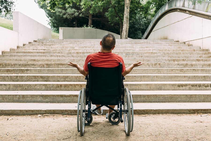 Man in wheelchair in front of steps